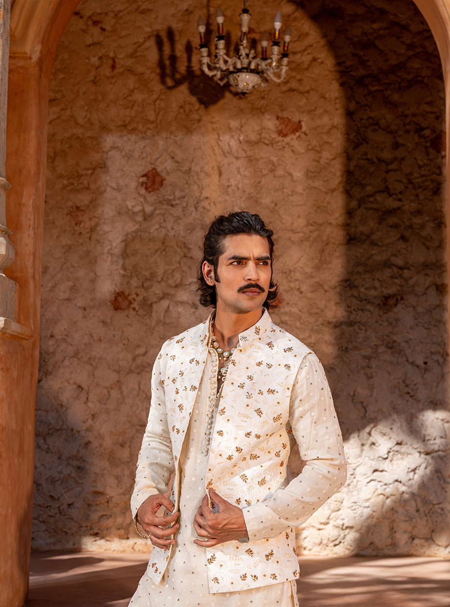 IVORY CHANDERI MUKAISH WORK KURTA + DHOTI PARIED WITH FLORAL EMBROIDERED BUNDI EXAGGERATED WITH MUKAISH FLORAL HAND EMBROIDERY Nafsstore