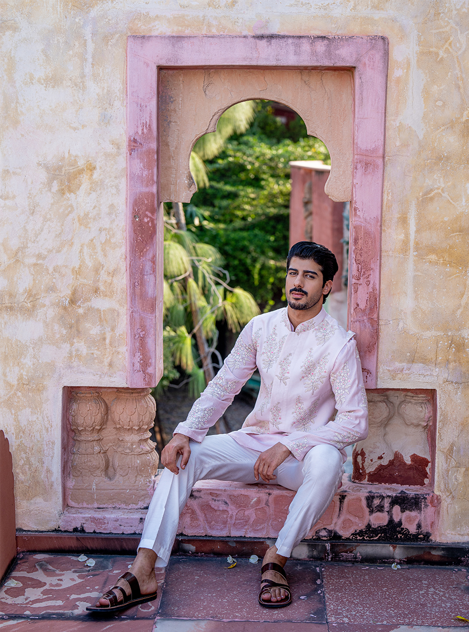 PASTEL PINK SATIN LINEN KURTA WITH CHANDERI PASTEL PINK FLORAL EMBROIDERED SLEEVES PAIRED WITH PASTEL PINK FLORAL EMBROIDERED BUNDI + WHITE SATIN LINEN PANT Nafsstore