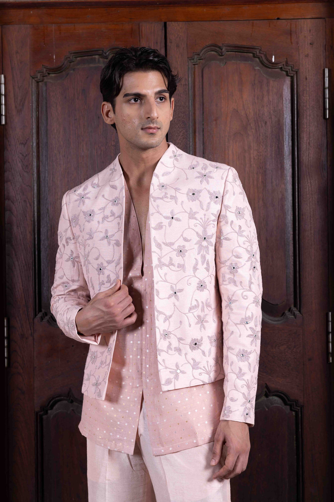 Salmon pink tussar silk jacket with resham, kasab and mirror dori work paired with mettalic polka dotted chanderi shirt and tussar silk flared pant Nafsstore