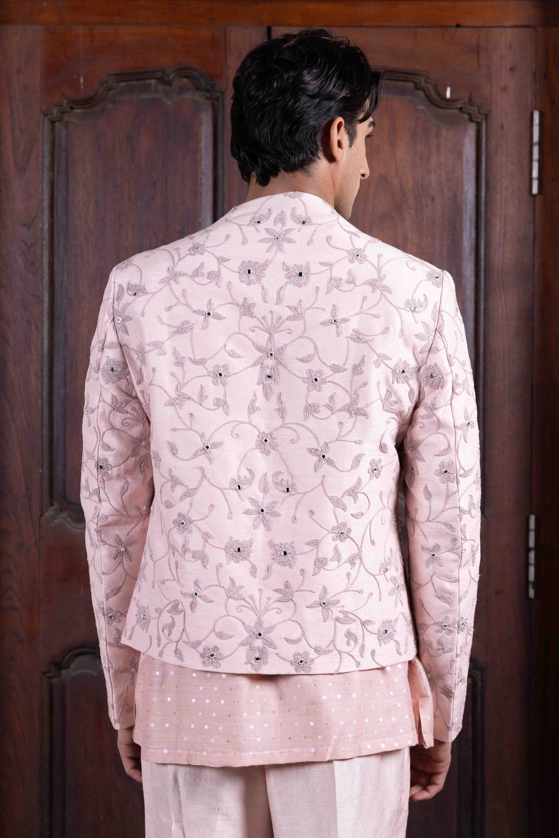 Salmon pink tussar silk jacket with resham, kasab and mirror dori work paired with mettalic polka dotted chanderi shirt and tussar silk flared pant Nafsstore